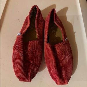 TOMS red corduroy slip ons.